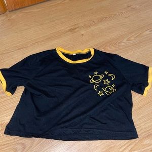 medium black and yellow crop top with planets and stars